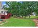 Lush backyard featuring mature trees, a well-kept lawn, and a deck at 1480 Big Leaf Loop, Apex, NC 27502