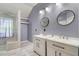 Elegant bathroom featuring a marble floor, glass enclosed shower, and double vanity with modern fixtures at 1480 Big Leaf Loop, Apex, NC 27502