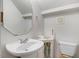A bright half bath with a unique sink basin, cabinet, toilet, and decorative mirror at 1480 Big Leaf Loop, Apex, NC 27502