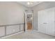 Bedroom featuring soft carpet, a panel wall, an open doorway, and a double door closet at 1480 Big Leaf Loop, Apex, NC 27502