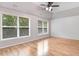 Bright bedroom with vaulted ceiling, ceiling fan, and large windows with blinds at 1480 Big Leaf Loop, Apex, NC 27502