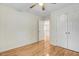 Spare bedroom with hardwood floors, a ceiling fan, a double door closet, and white walls at 1480 Big Leaf Loop, Apex, NC 27502