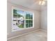 Bedroom with a large window providing outdoor views, a ceiling fan, and light gray walls at 1480 Big Leaf Loop, Apex, NC 27502