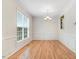 Formal dining room featuring hardwood floors, classic wainscoting, and elegant chandelier at 1480 Big Leaf Loop, Apex, NC 27502