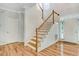Bright foyer features hardwood floors, staircase, and natural light from nearby windows at 1480 Big Leaf Loop, Apex, NC 27502