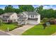 A two-story home with a welcoming front porch and a well-manicured lawn at 1480 Big Leaf Loop, Apex, NC 27502