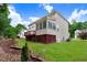 Two-story home showcasing a back deck, screened-in porch, and well-maintained lawn at 1480 Big Leaf Loop, Apex, NC 27502