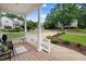 Welcoming front porch with white columns and railings, offering a charming outdoor space at 1480 Big Leaf Loop, Apex, NC 27502