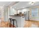 Modern kitchen with white cabinets, granite countertops, stainless steel appliances, and breakfast bar seating at 1480 Big Leaf Loop, Apex, NC 27502