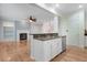 Kitchen island overlooks the living room with hardwood floors and a cozy fireplace at 1480 Big Leaf Loop, Apex, NC 27502