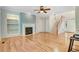 Cozy living room with a fireplace, built-in shelves, hardwood floors, and staircase at 1480 Big Leaf Loop, Apex, NC 27502