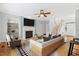 Stylishly furnished living room with fireplace, TV, comfortable seating, and hardwood floors at 1480 Big Leaf Loop, Apex, NC 27502