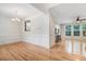 Open-concept living room with hardwood floors, crown molding, and a ceiling fan at 1480 Big Leaf Loop, Apex, NC 27502