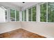 Enclosed sun room featuring multiple windows with natural light and tile floors at 1480 Big Leaf Loop, Apex, NC 27502