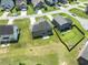 Aerial view of backyard and neighborhood featuring a brick home with patio at 1499 Fireside Ln, Creedmoor, NC 27522