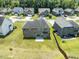 An aerial view of a well-maintained backyard with a brick home and the surrounding neighborhood at 1499 Fireside Ln, Creedmoor, NC 27522
