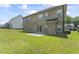 Brick home backyard with green grass and sliding glass doors to patio at 1499 Fireside Ln, Creedmoor, NC 27522