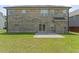 View of large brick home with patio and expansive backyard and green lawn at 1499 Fireside Ln, Creedmoor, NC 27522