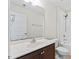 Bathroom featuring a white sink and toilet, dark wood vanity, and shower with tile surround at 1499 Fireside Ln, Creedmoor, NC 27522