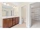 Bathroom with double vanity, tile flooring, and access to a walk-in closet at 1499 Fireside Ln, Creedmoor, NC 27522