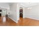 Open-concept dining room with hardwood floors and elegant chandelier at 1499 Fireside Ln, Creedmoor, NC 27522
