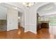Open dining room with hardwood floors, chandelier, and arched doorway to kitchen and other rooms at 1499 Fireside Ln, Creedmoor, NC 27522