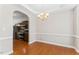 Bright dining room with crown molding, wood floors, and a view into the adjacent, modern kitchen at 1499 Fireside Ln, Creedmoor, NC 27522