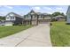 Attractive home featuring a long driveway and a well-maintained lawn, with lovely curb appeal at 1499 Fireside Ln, Creedmoor, NC 27522
