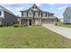 Beautiful two-story home with a lush lawn and a paved driveway leading to an attached garage at 1499 Fireside Ln, Creedmoor, NC 27522