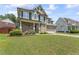Beautiful exterior view of the two-story home with a well-kept lawn and mature landscaping at 1499 Fireside Ln, Creedmoor, NC 27522