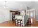 Modern kitchen featuring breakfast bar with seating, stainless steel appliances, and ample cabinet space at 1499 Fireside Ln, Creedmoor, NC 27522