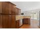 A kitchen featuring dark wood cabinets, granite countertops, stainless steel appliances, and wood flooring at 1499 Fireside Ln, Creedmoor, NC 27522