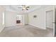 Bright and large primary bedroom featuring carpeted flooring, a ceiling fan, and access to the Primary bath at 1499 Fireside Ln, Creedmoor, NC 27522