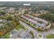 Aerial view of neighborhood with a playground, mature trees and landscaping at 15 Treviso Pl, Durham, NC 27707