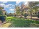 Backyard featuring a lush green lawn, manicured landscaping, and black metal fence at 15 Treviso Pl, Durham, NC 27707