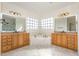 Primary bathroom with marble floors, a corner tub, and double vanity sinks at 15 Treviso Pl, Durham, NC 27707