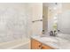 Bathroom with marble tiled walls, vanity, and tub at 15 Treviso Pl, Durham, NC 27707