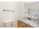 Bathroom featuring a wood vanity, marble countertops, and large mirror at 15 Treviso Pl, Durham, NC 27707