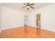 Bedroom with ceiling fan, hardwood floors, and access to bathroom and hallway at 15 Treviso Pl, Durham, NC 27707