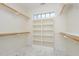 Walk-in closet with custom shelving and a window at 15 Treviso Pl, Durham, NC 27707