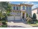 Stunning two-story home with a two-car garage, ornate front entrance and stone paver driveway and walkway at 15 Treviso Pl, Durham, NC 27707