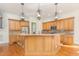 Gourmet kitchen featuring custom cabinetry, granite countertops, stainless steel appliances, and a center island at 15 Treviso Pl, Durham, NC 27707