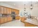 Well-appointed kitchen with stainless steel appliances, granite counters, custom cabinets, and tile flooring at 15 Treviso Pl, Durham, NC 27707