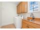 Laundry room featuring tile flooring, cabinetry, a sink and a washing machine at 15 Treviso Pl, Durham, NC 27707