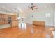 Spacious living room with hardwood floors, built-in cabinetry, and a view of the kitchen at 15 Treviso Pl, Durham, NC 27707