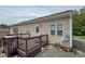 View of the back deck of the home, with a brown rail at 153 Bywood Dr, Roxboro, NC 27573