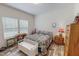 Bedroom with white walls, a wooden dresser, wood floors, and natural light at 153 Bywood Dr, Roxboro, NC 27573