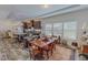 Dining room with a wooden table set and open concept view of the modern kitchen area at 153 Bywood Dr, Roxboro, NC 27573