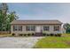 Inviting single-story home features a charming entrance and well-maintained landscaping at 153 Bywood Dr, Roxboro, NC 27573