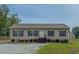 Traditional home with charming curb appeal, complemented by lush landscaping at 153 Bywood Dr, Roxboro, NC 27573